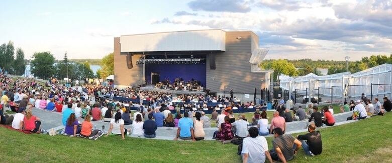 People sitting in front of an amphitheatre.