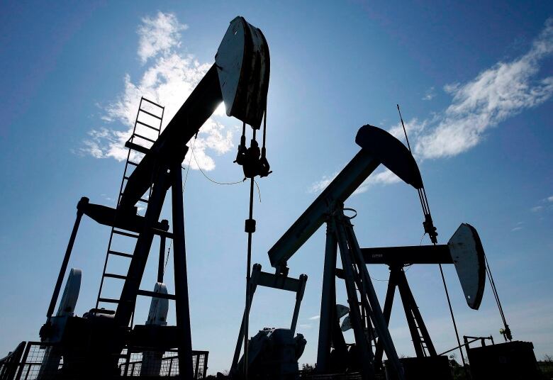 Pumpjacks under blue skies.