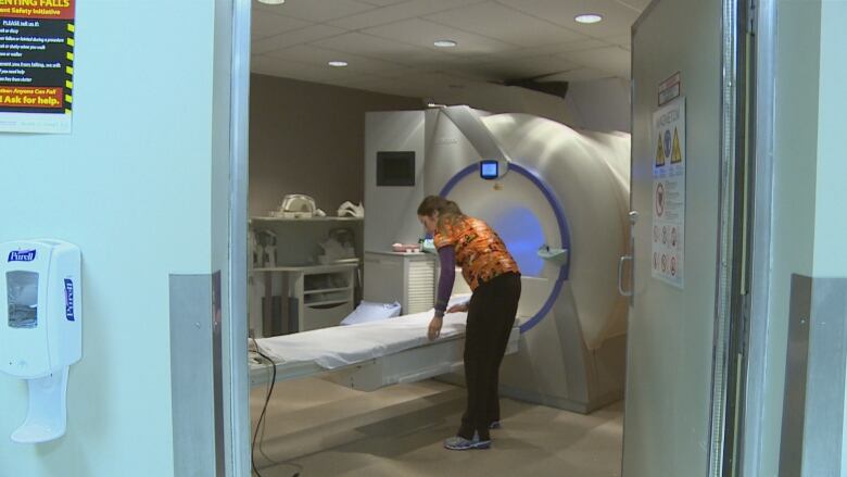 A person prepares an MRI machine.