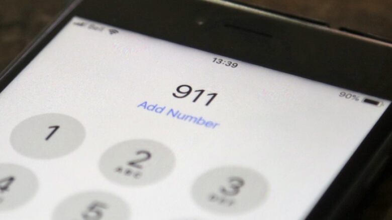 The numbers 911 on a cell phone screen.