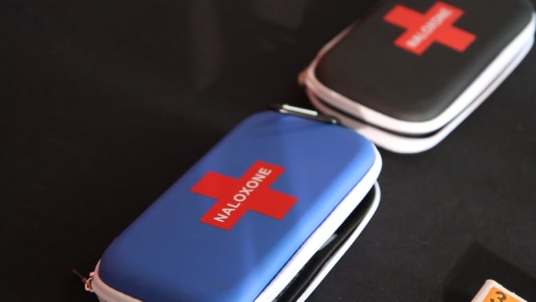 Two naloxone kits on a black background