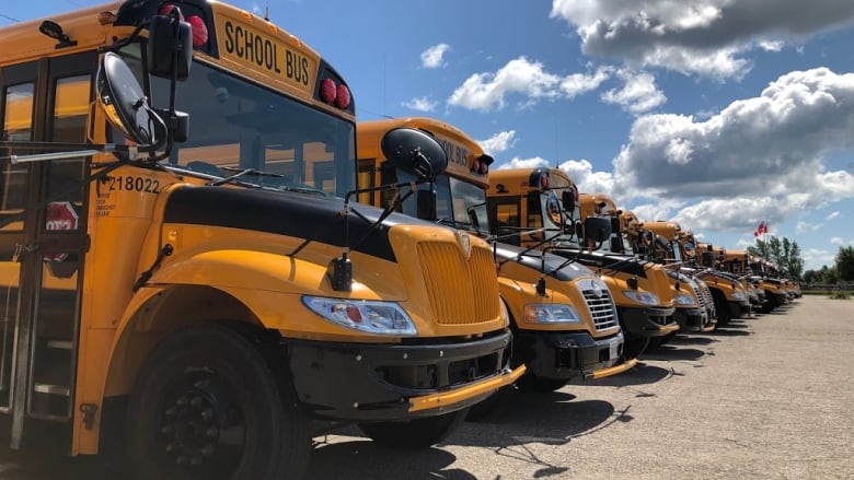 Yellow school buses parked in a parking lot