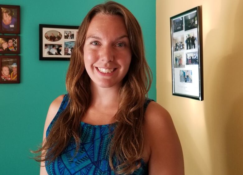 A smiling woman with long brown hair.