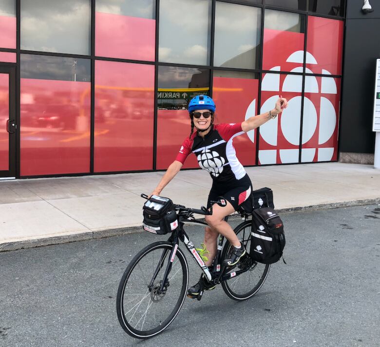 A woman is seen on a bike.