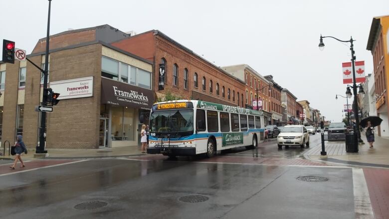 A city bus on a rainy street.