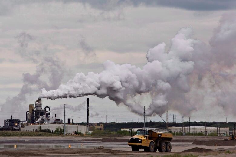 A dump truck works near the Syncrude oil sands extraction facility near the city of Fort McMurray, Alta., on June 1, 2014.