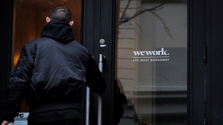 A man enters an office building.