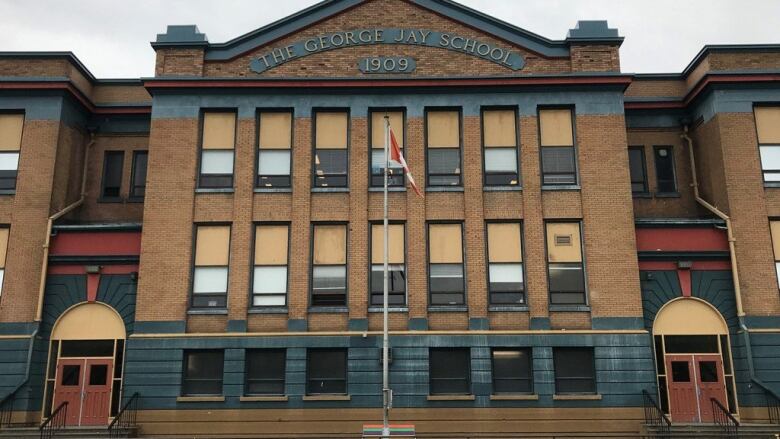 An imposing brick building says 