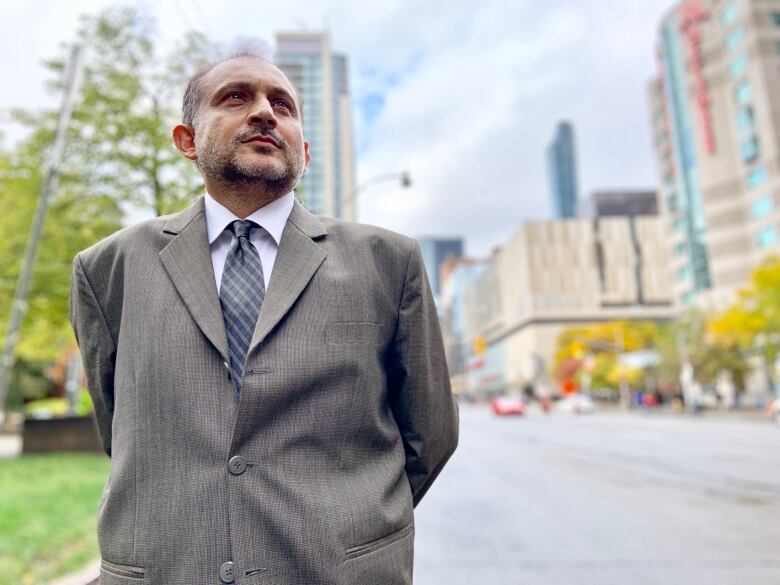 A man, Murtaza Haider, is shown standing in the sunshine.