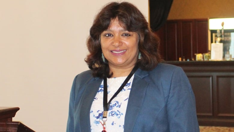 A woman poses for a photo in an office 