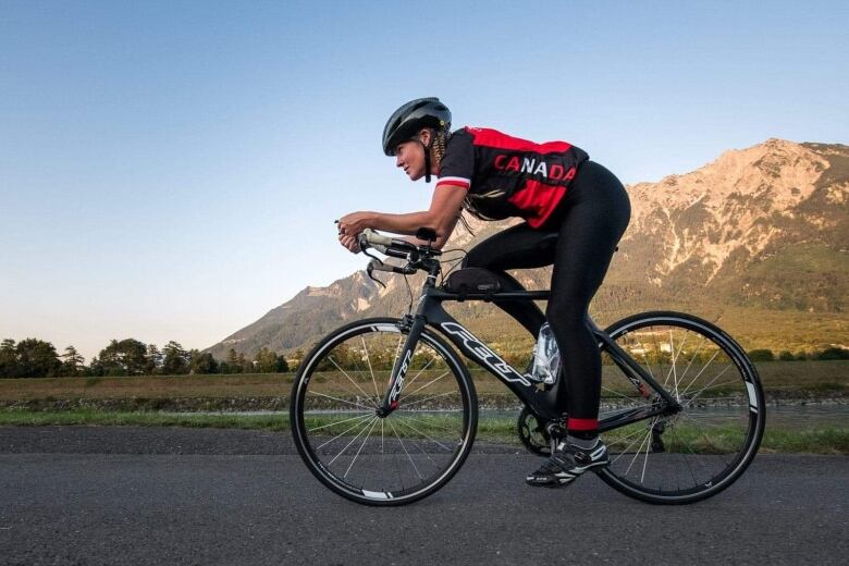 Athlete in a bike racing a long a mountain road