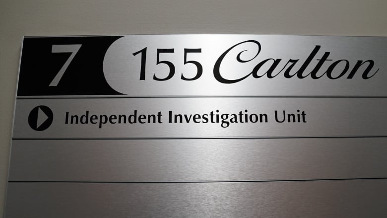 A silver plate with black lettering reads Independent Investigations unit. 