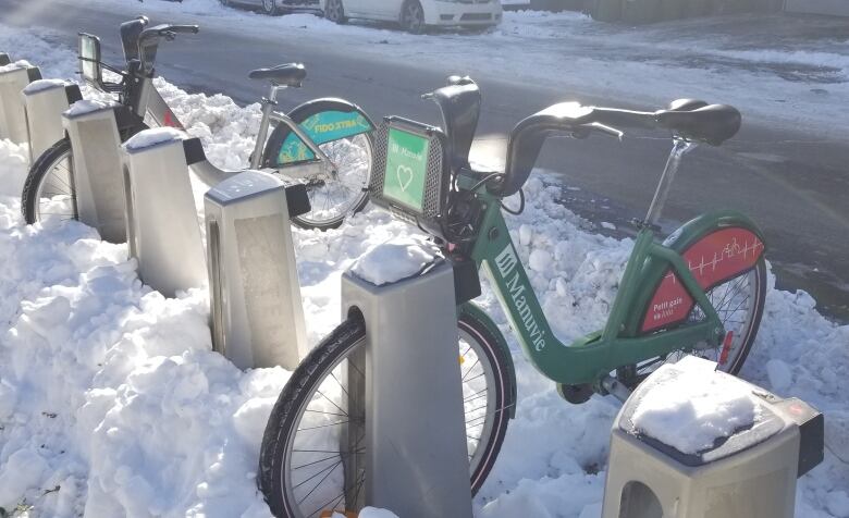 Bikes covered in snow.