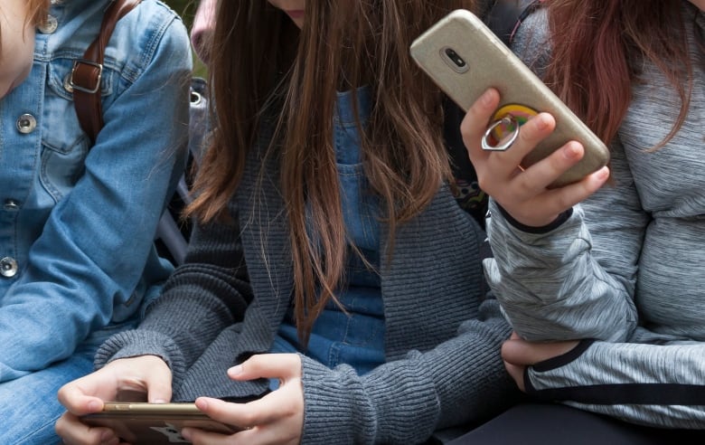 Women using their phones.