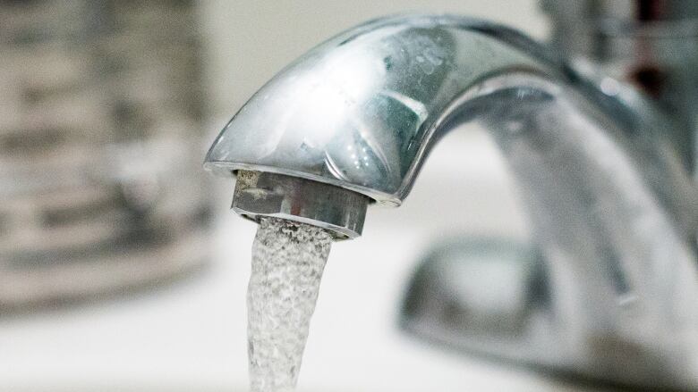 Water coming out of a faucet.