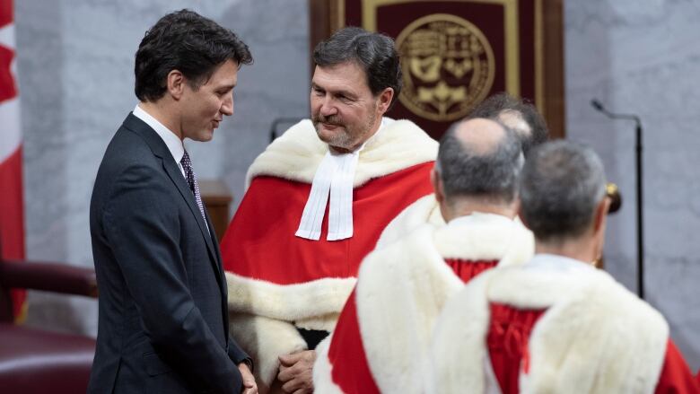 Prime Minister Justin Trudeau speaks with Supreme Court Chief Justice Richard Wagner as they wait for the Speech from the Throne to begin, Thursday December 5, 2019 in Ottawa. 