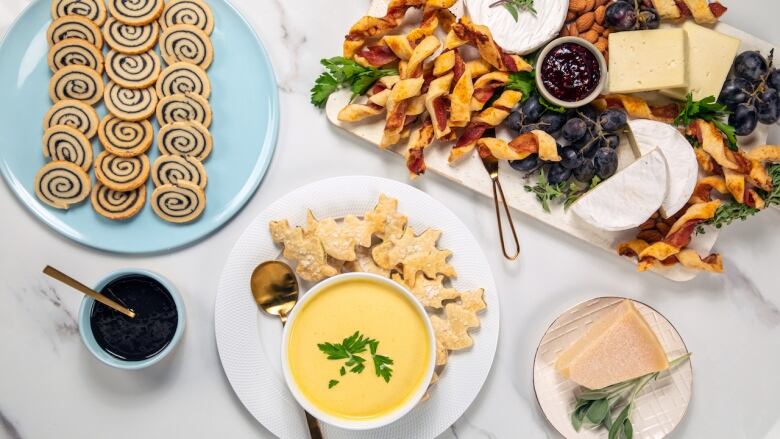 Overhead shot of 3 treats made from leftover pie dough: black sesame pinwheels, crackers and bacon pie sticks. 