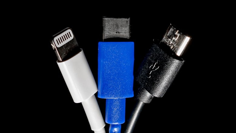 Three charging cords against a black background - a white lighting charger on the left, a blue USB-C charger in the middle and a black mini USB cable on the right.