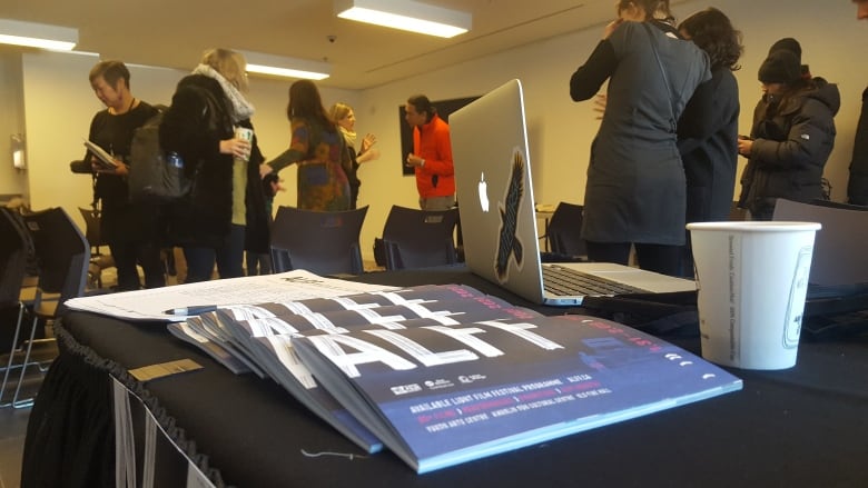 A series of posters -- reading ALFF -- appear on a black table.