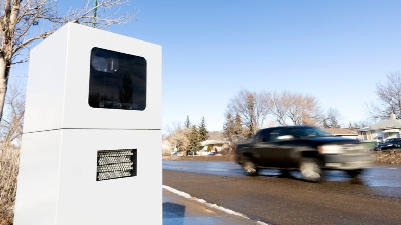 A black truck drives past a photo speed enforcement device in Regina. 