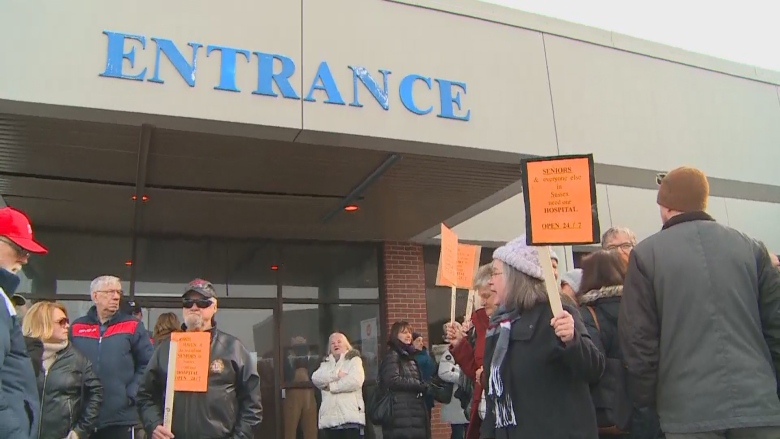 People picket outside a hospital in Sussex, N.B.