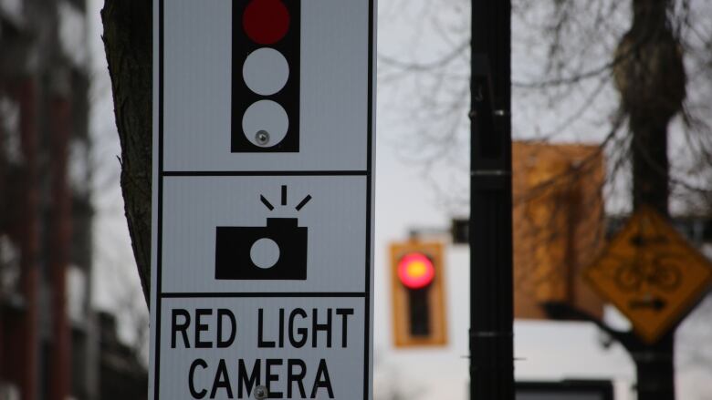 road sign reading red light camera