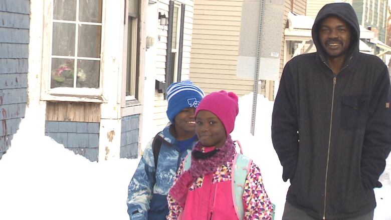 Ismail walks to St. Jean Elementary with Loui and Lojiean