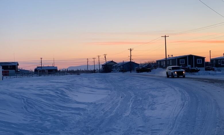 The sun sets in a northern community in winter.