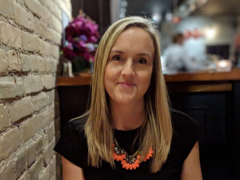 woman in restaurant looks at camera