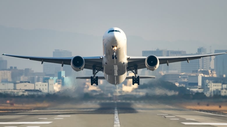 An airplane takes off on a runway.