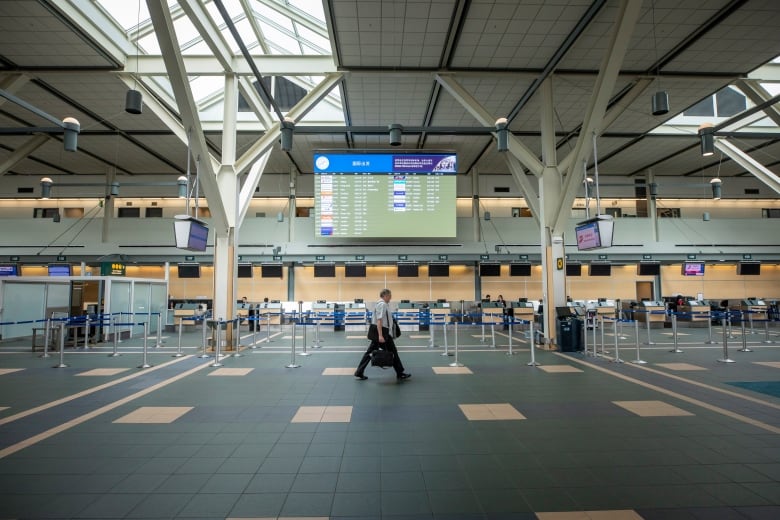 A passenger walks through an empty floor at Vancouver's International Airport. 