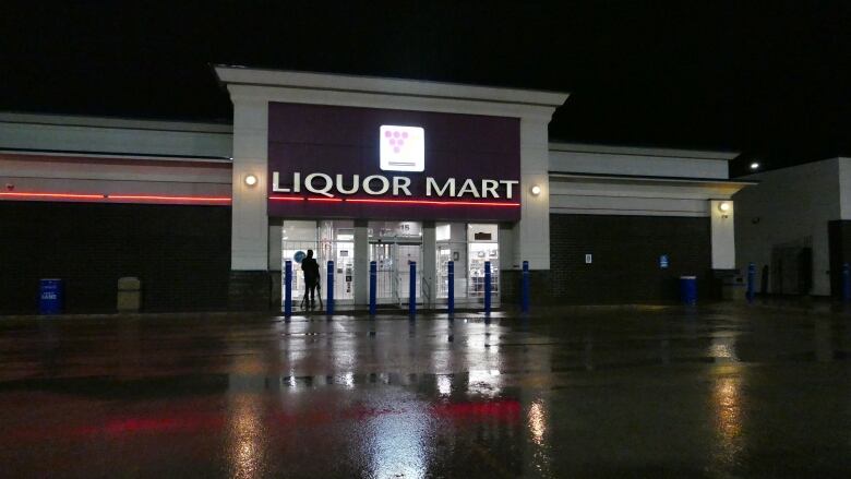 The exterior of a Manitoba Liquor Mart building is shown outside in the evening.