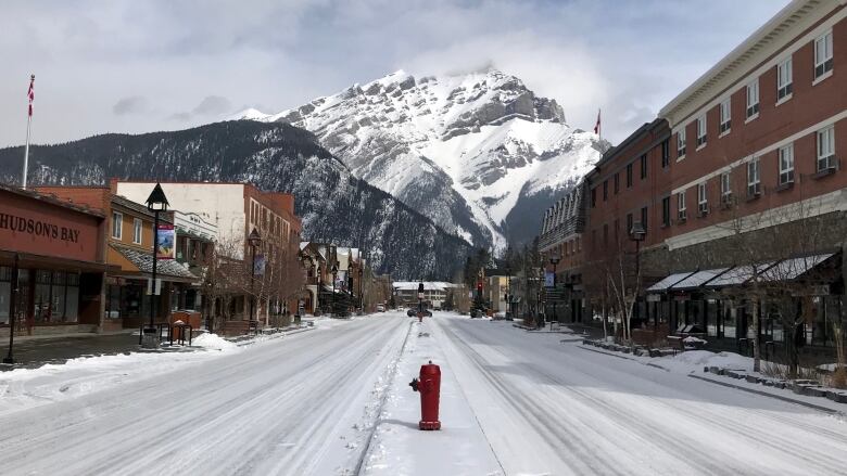 a picture of a snowy road with a mountain in the background