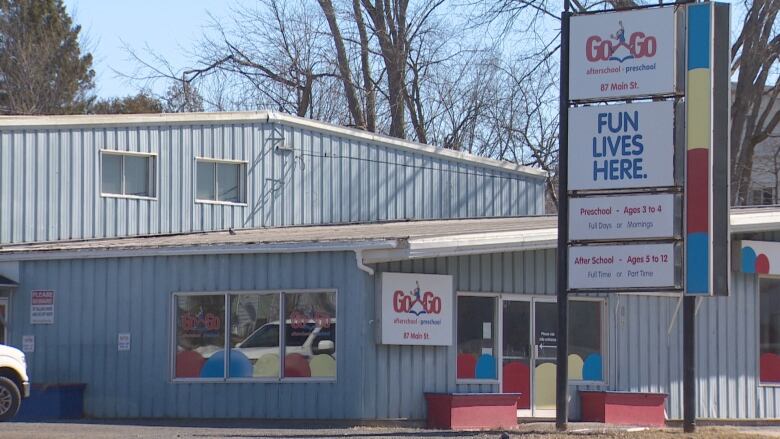 A blue building with a sign that says 