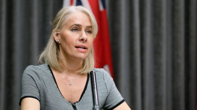 A woman speaks at a news conference.