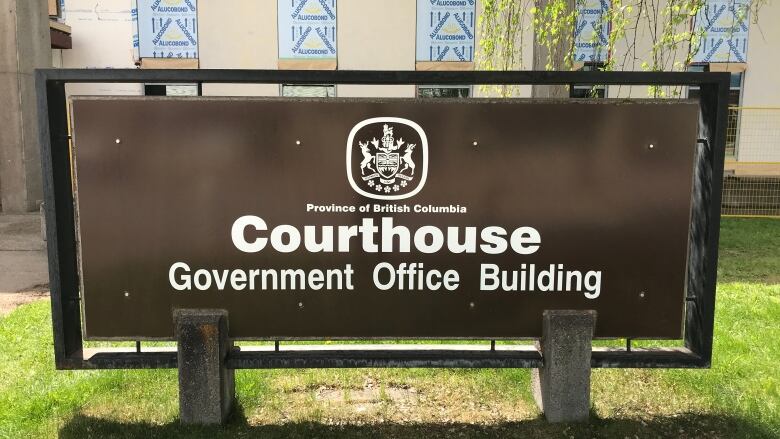 A brown sign outside a provincial courthouse in Smithers B.C.