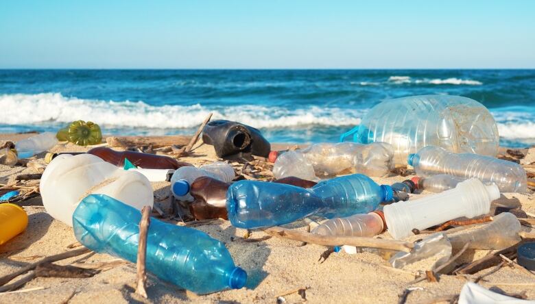 Plastic waste covers a beach.