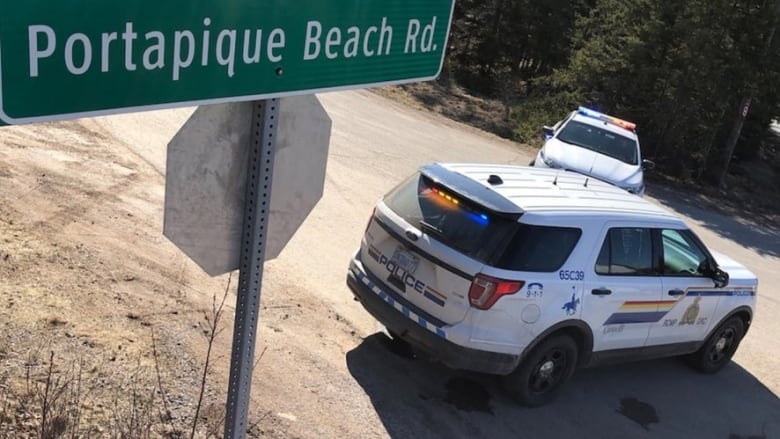 The road sign of Portapique Beach Road is shown next to an RCMP cruiser.