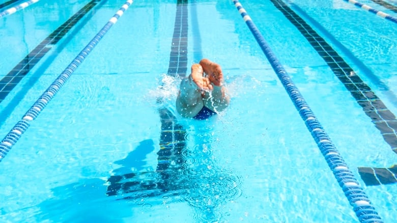 A person diving into a pool.