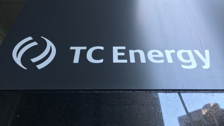 A close-up sign with the words, TC Energy in white on a black background.