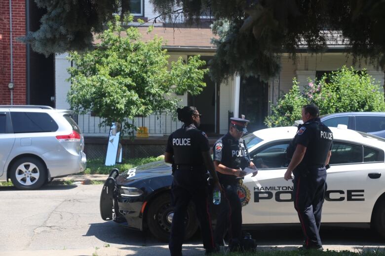 Police in front of a house.