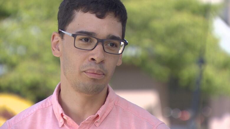 A younger white man with glasses speaks.