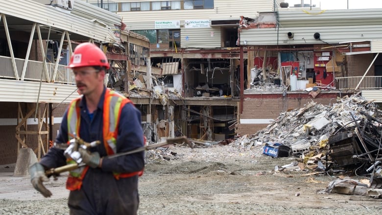 A worker walks through the remains of the Algo Centre mall in Elliot Lake, which collapsed on June 23, 2012. 