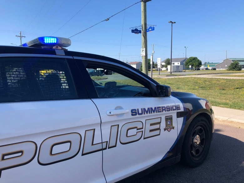 Summerside police cruiser parked near grassy area.