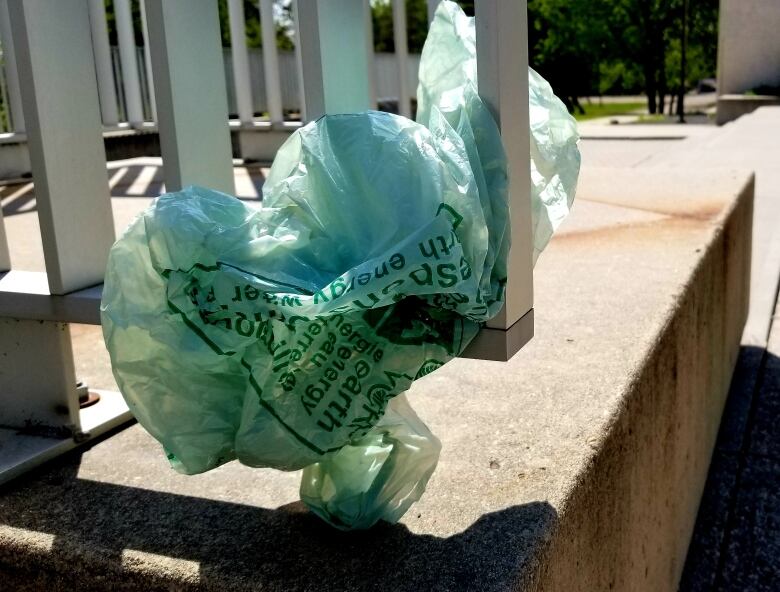 A plastic bag trapped in a metal grate.