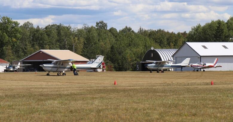 Airplanes in field at rural airport 