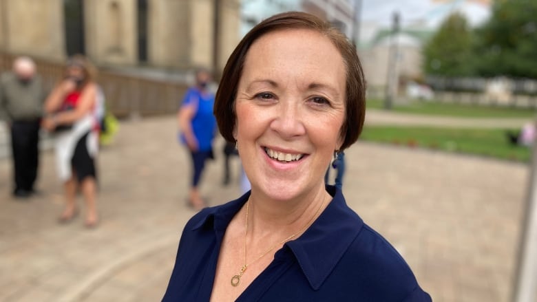 A woman smiles outside the legislature.