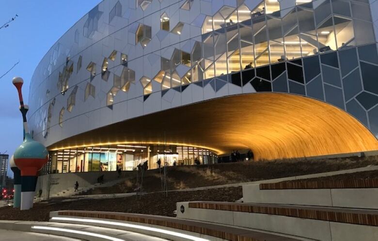 A warm glow reflects the wood used in the arch at the main entrance to the library. 