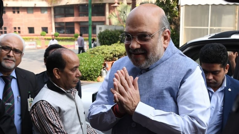 India Home Minister Amit Shah gestures as he arrives at the Parliament in New Delhi on March 2, 2020.