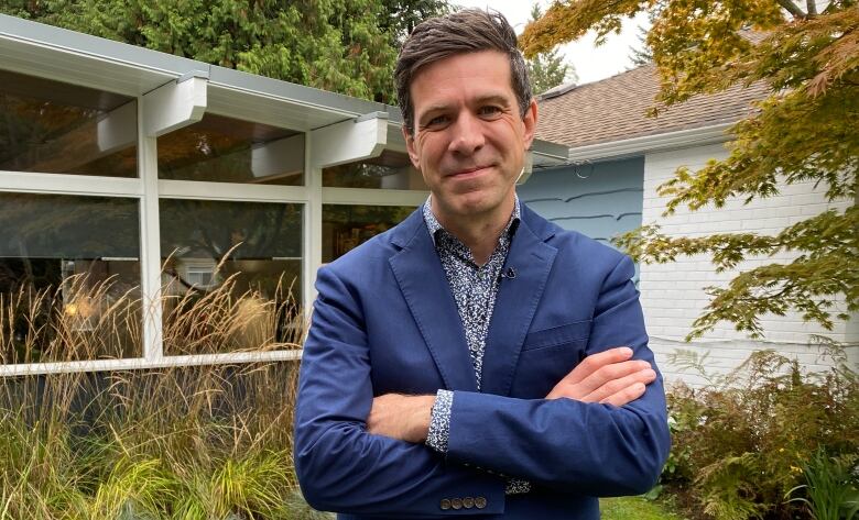 A man stands in a green grassy lawn.